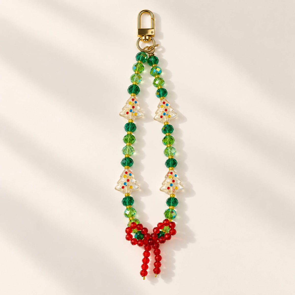 Included project: Bow beaded phone and bag charm with gold-tone clasp.