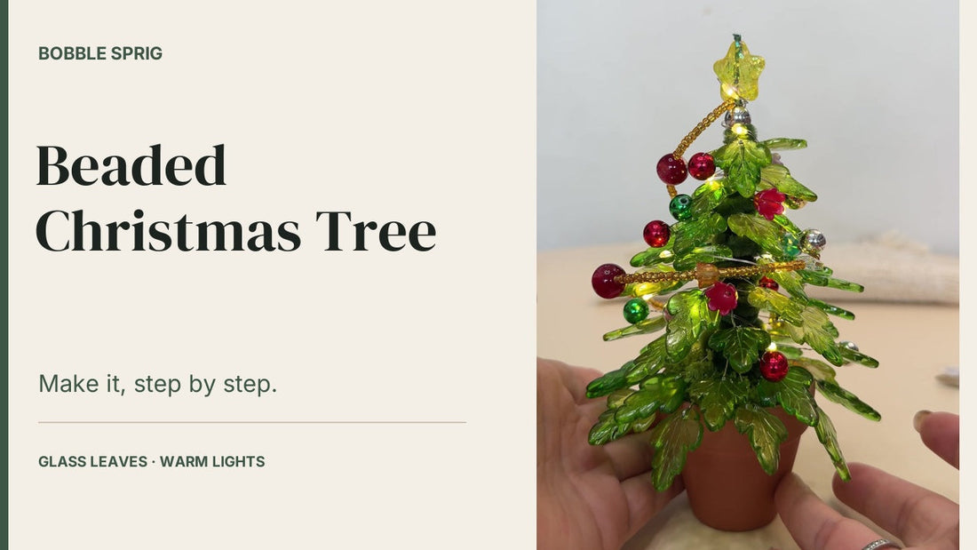Beaded Christmas tree cover: a lit glass-leaf Christmas tree in a terracotta pot, held in one hand, with the Bobble Sprig title card alongside it.