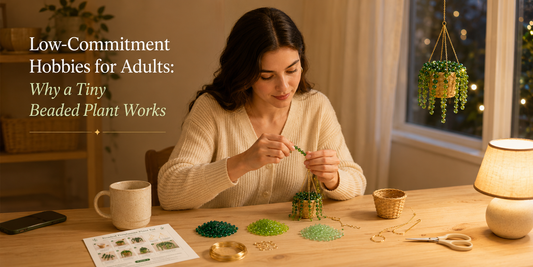 Young woman making a Bobble Sprig beaded hanging plant kit as a low-commitment evening hobby at a cozy craft table.