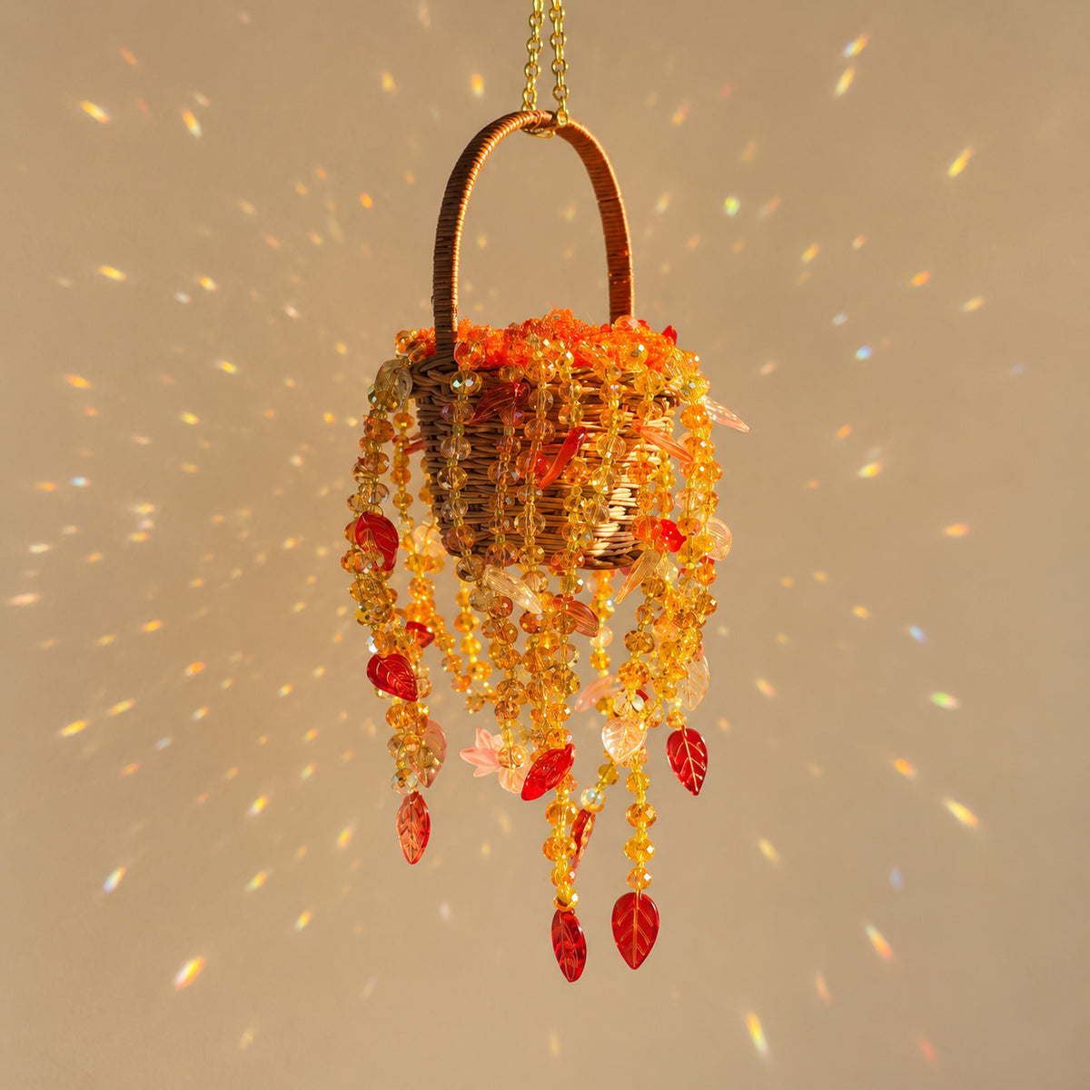 Autumn Dusk beaded hanging basket with amber AB glass beads, red leaf beads and gold seed beads in natural sunlight