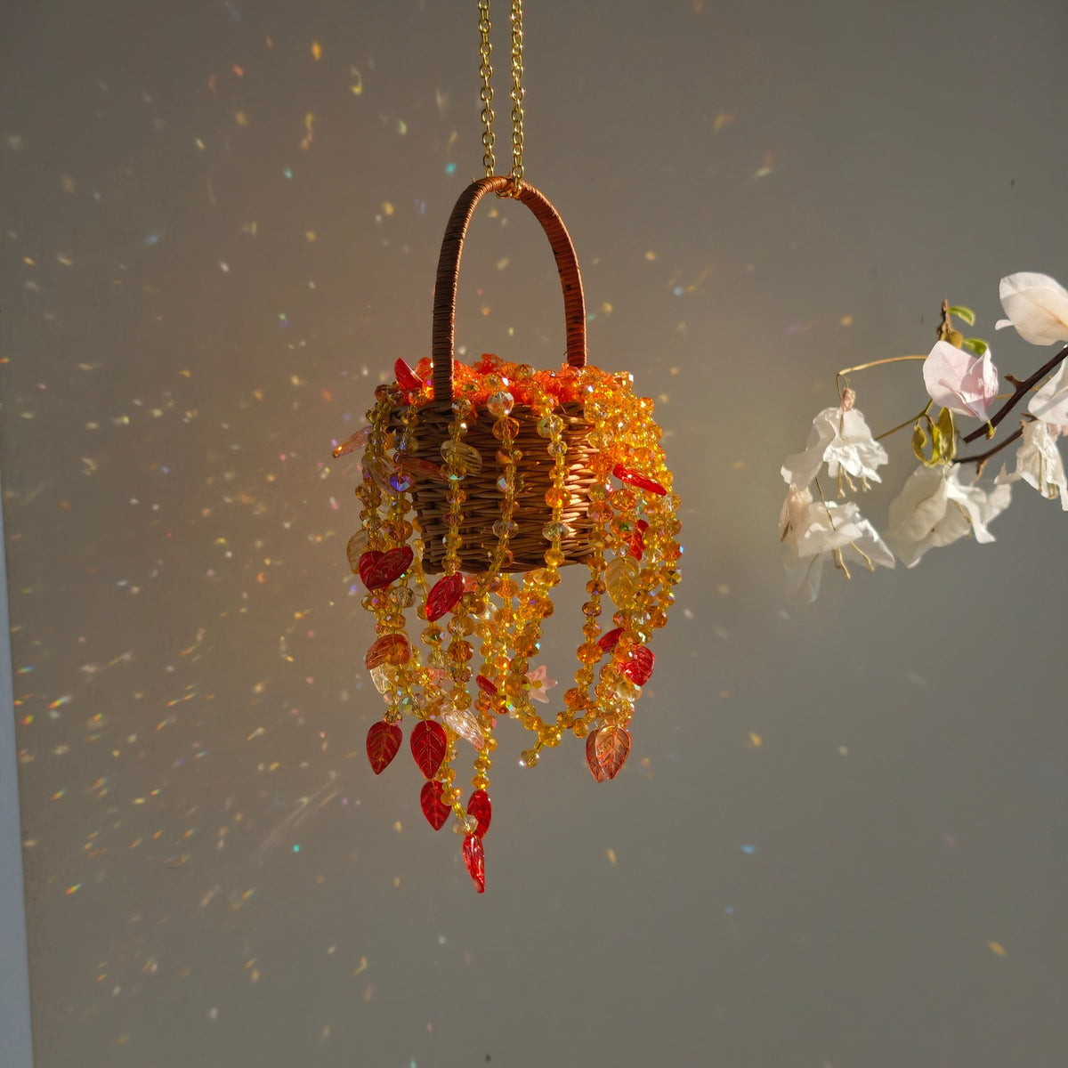 Autumn Dusk hanging basket with glass bead strands reflecting colorful sunlight