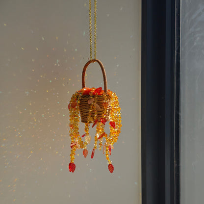 Autumn Dusk beaded hanging basket beside a window with natural refracted light