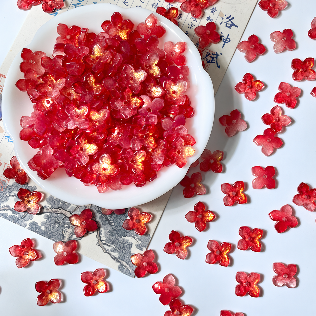 10mm four-petal glass hydrangea beads in Ruby Red Gold, 50 pieces per pack