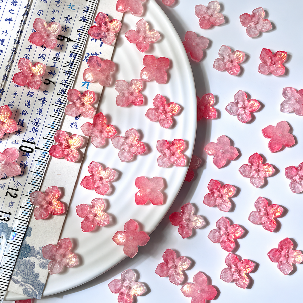 12mm four-petal glass hydrangea beads in Rose Pink Gold, 50 pieces per pack