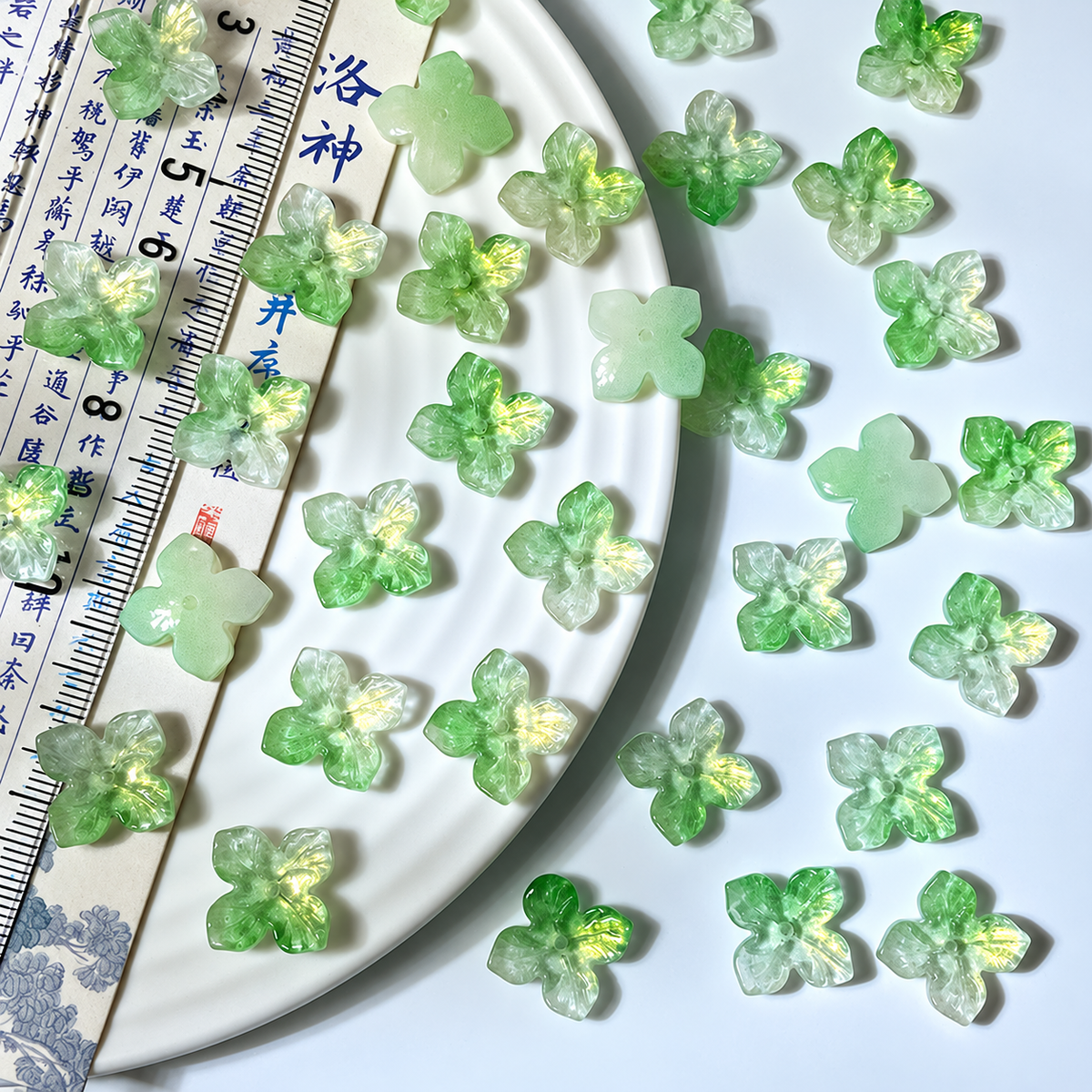 14mm four-petal glass hydrangea beads in Milky Green Gold, 50 pieces per pack