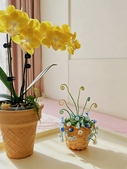 Close-up of bluebell beaded plant flowers and green bead stems