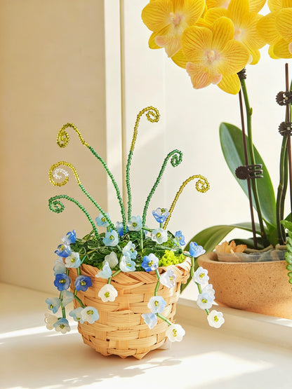 Finished bluebell beaded plant basket with curled green vines