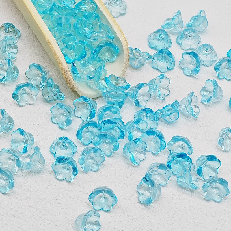 7 x 12 mm glass lily of the valley flower beads in transparent blue - 50 beads per pack