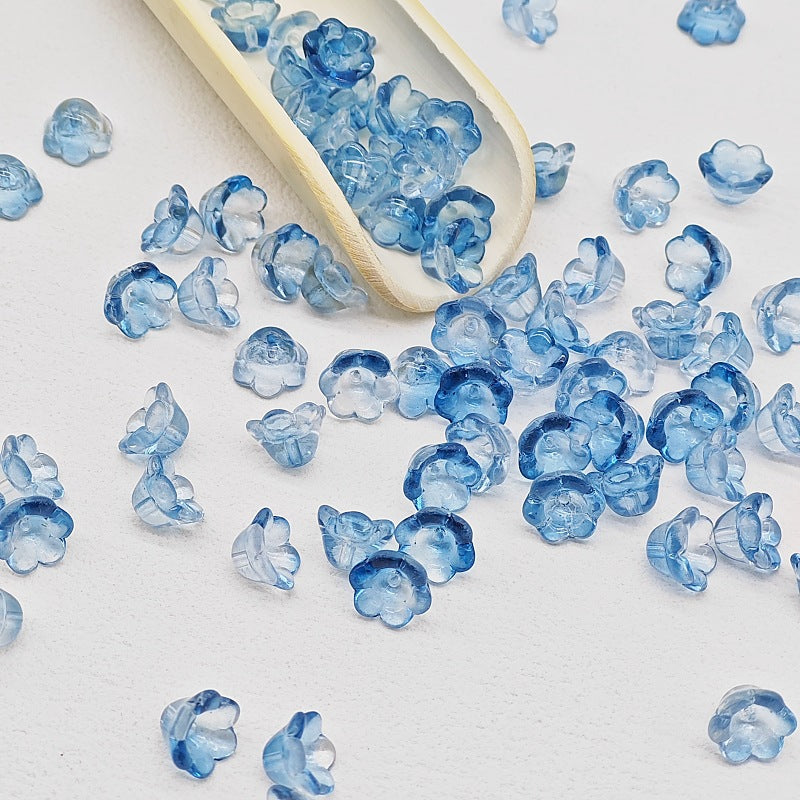 7 x 12 mm glass lily of the valley flower beads in transparent ink blue - 50 beads per pack