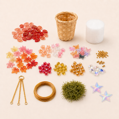 Autumn Garden DIY kit contents with mixed glass beads, woven basket, faux grass, gold chain, wire, foam and two star stickers
