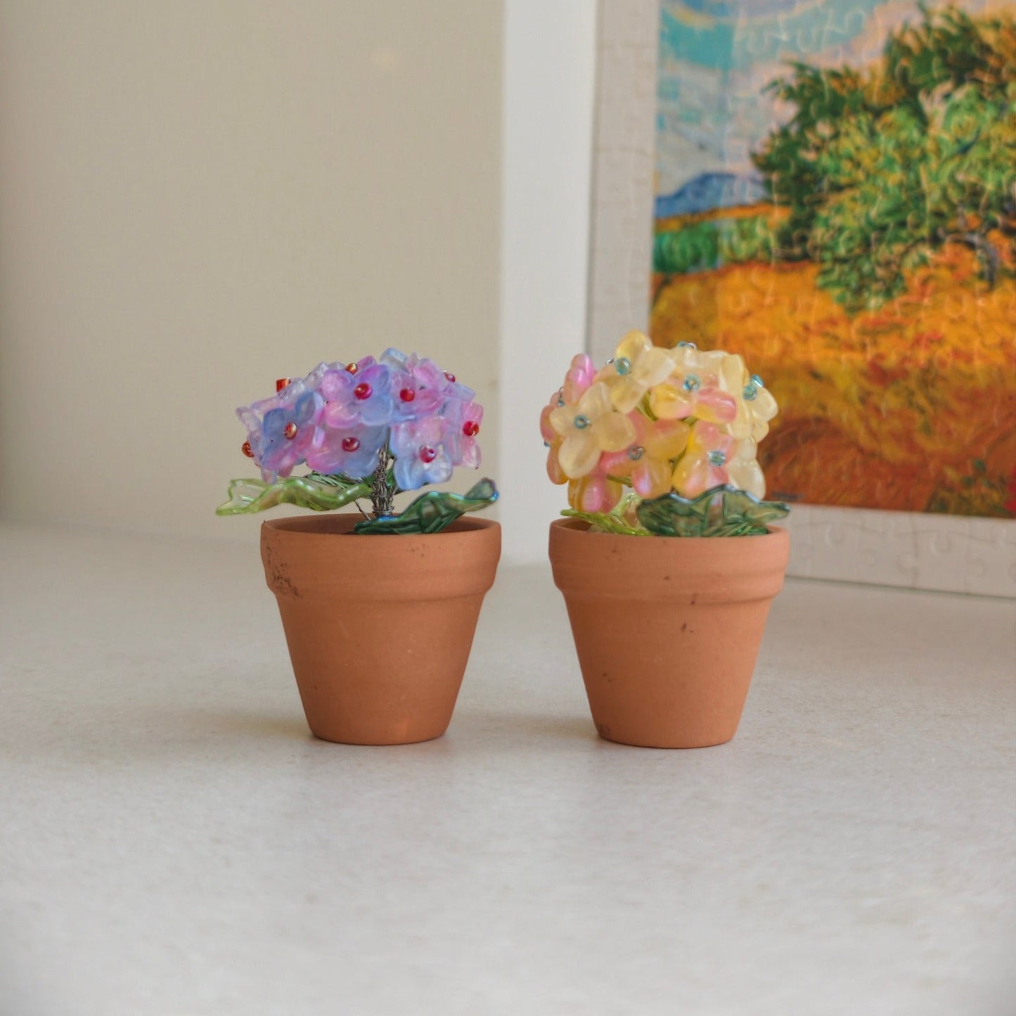 Purple and yellow beaded hydrangea mini pots displayed together in a cozy room