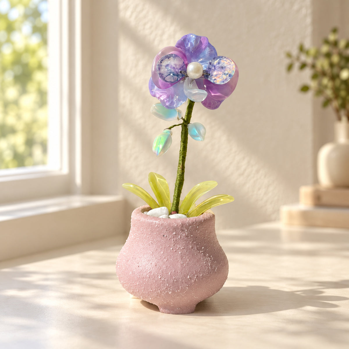 Purple beaded moth orchid in a textured pink pot on a sunlit desk — finished example