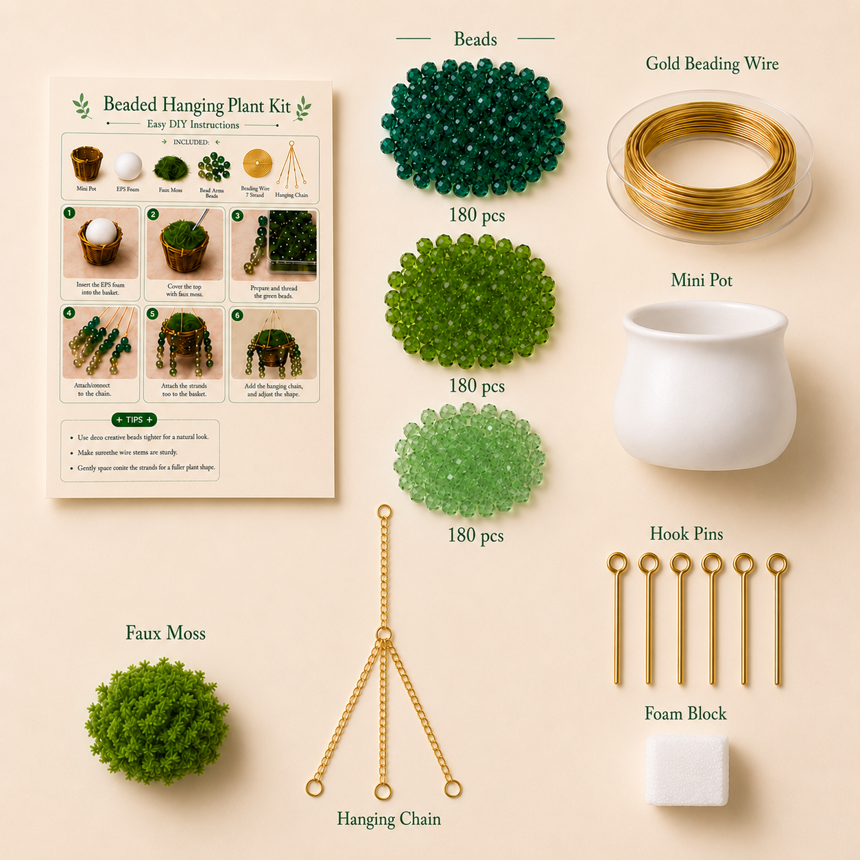 Beaded hanging plant kit with green beads, gold beading wire, mini pot, faux moss, and other components on a beige background.