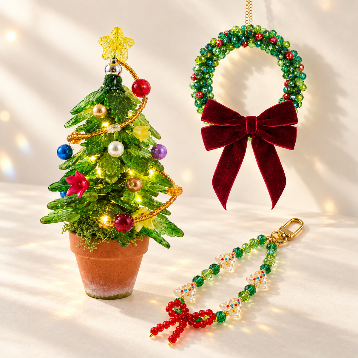 Christmas DIY kit bundle showing the finished Light Green beaded tree, Classic wreath with burgundy velvet bow, and Bow phone and bag charm.