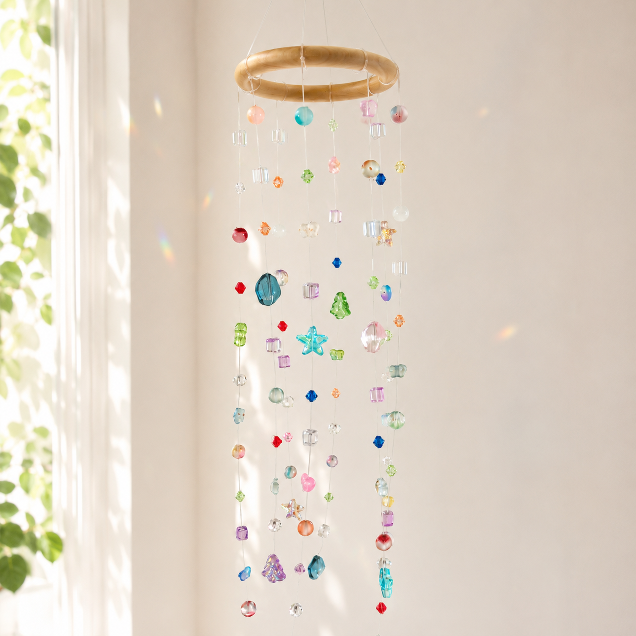 Colorful beaded hanging mobile suncatcher displayed in bright natural window light
