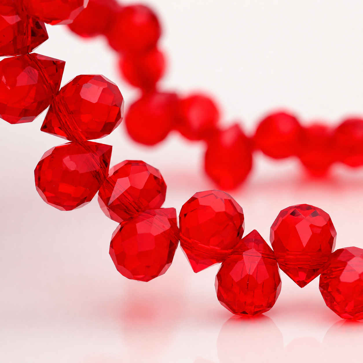 Vivid Red faceted teardrop K9 glass bead strand
