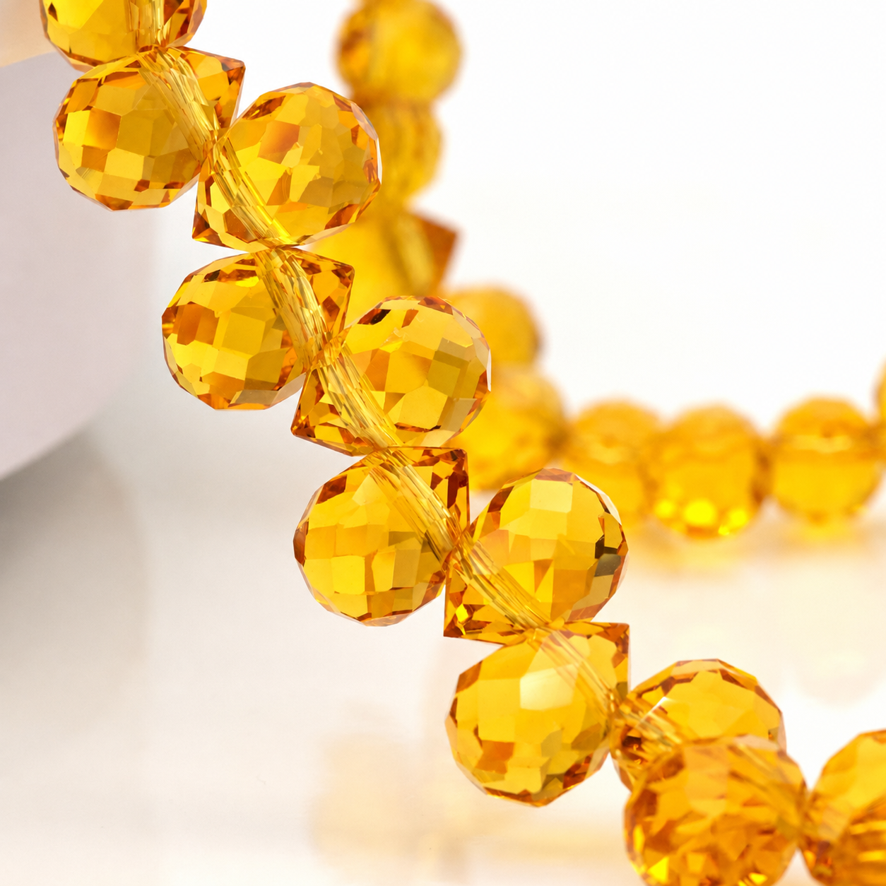 Deep Golden Yellow faceted teardrop K9 glass bead strand