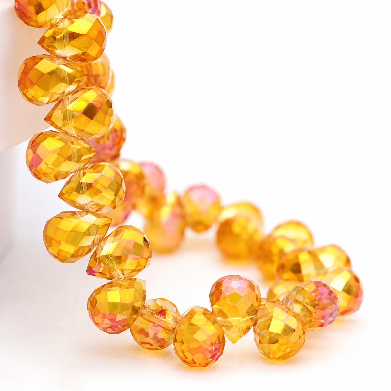 Golden Fuchsia faceted teardrop K9 glass bead strand