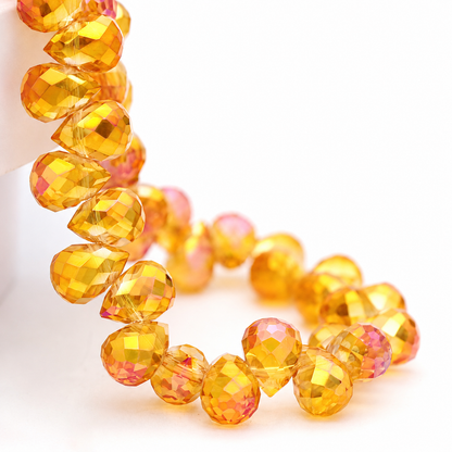 Golden Fuchsia faceted teardrop K9 glass bead strand