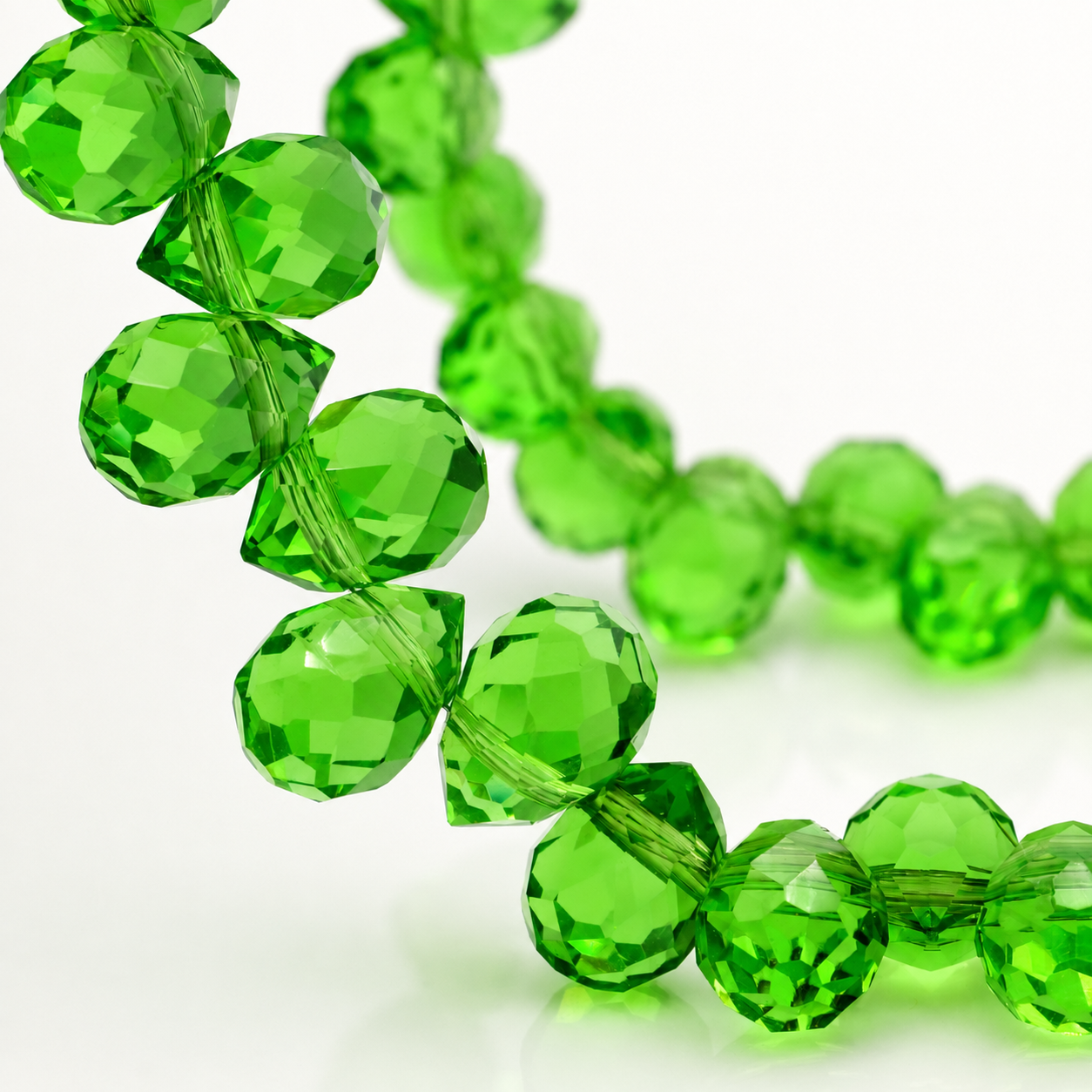 Grass Green faceted teardrop K9 glass bead strand