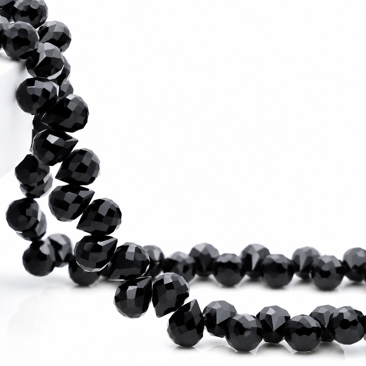 Black faceted teardrop K9 glass bead strand