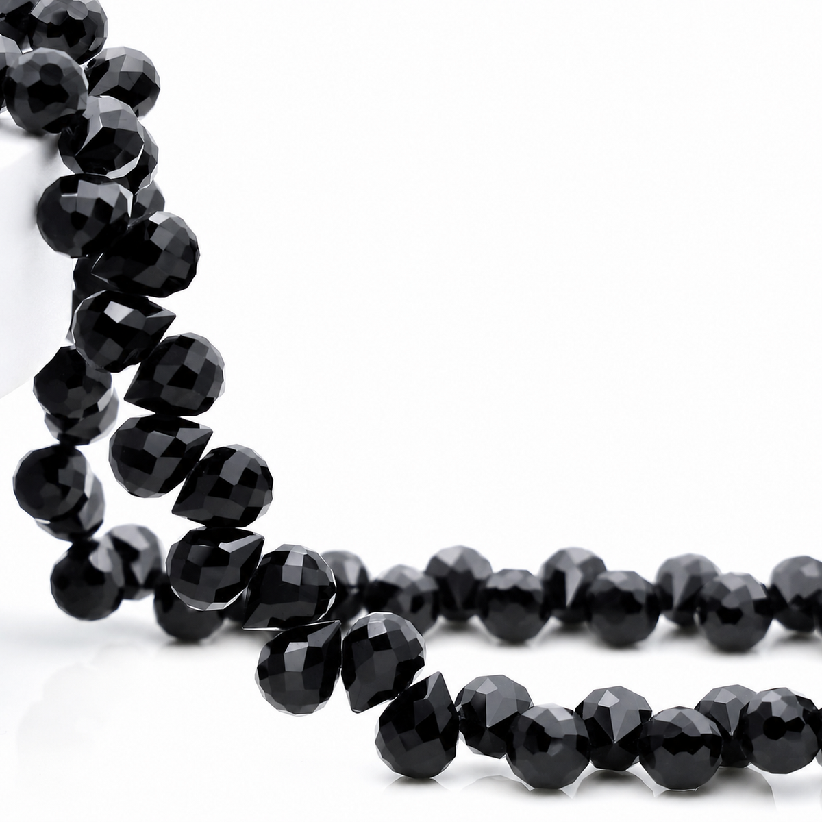 Black faceted teardrop K9 glass bead strand