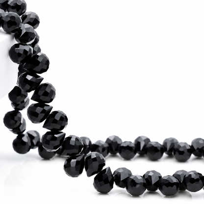 Black faceted teardrop K9 glass bead strand
