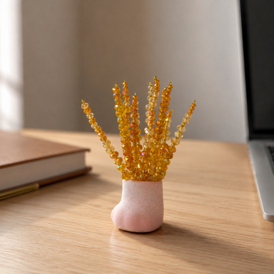Mini golden harvest wheat beaded plant on a naturally lit desk