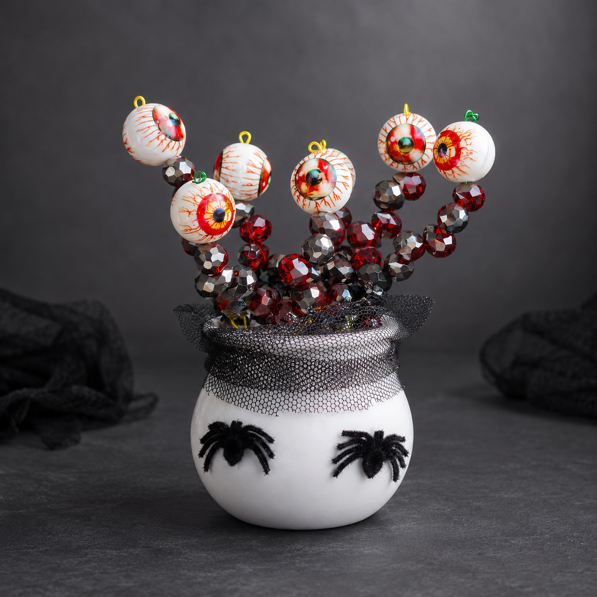 Halloween eyeball beaded plant front angle with two black spiders, square studio product photo