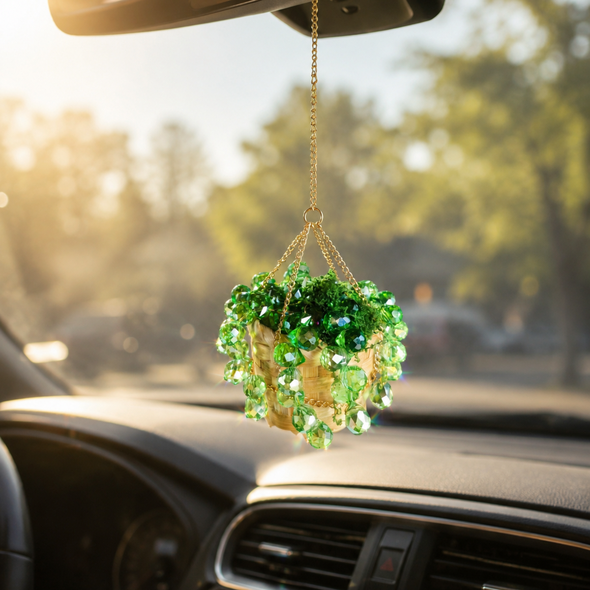 Mini green beaded plant car charm hanging from a rearview mirror