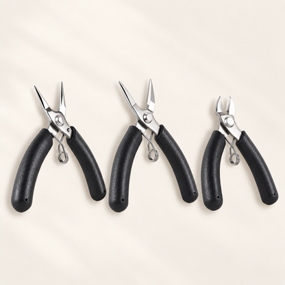 Three mini stainless steel jewelry tools with black handles: round-nose pliers, chain-nose pliers, and diagonal cutters