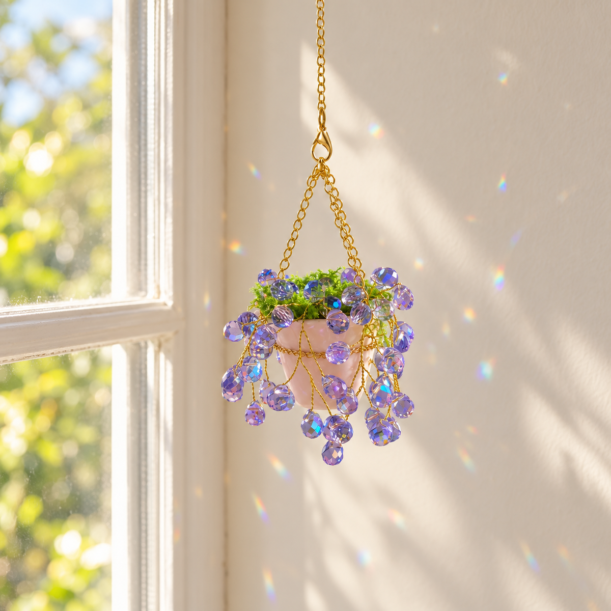 Mini purple beaded plant hanging beside a sunny window