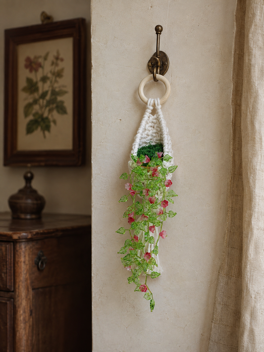 Pink beaded flower vine wall hanging styled in a warm vintage room