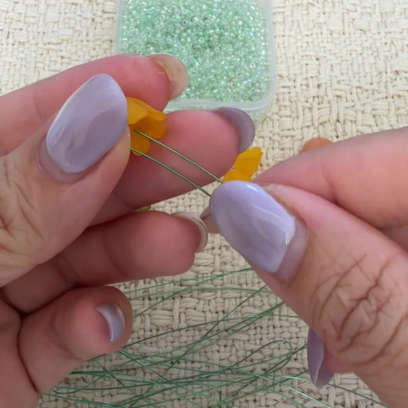 Both wire ends entering a yellow flower.