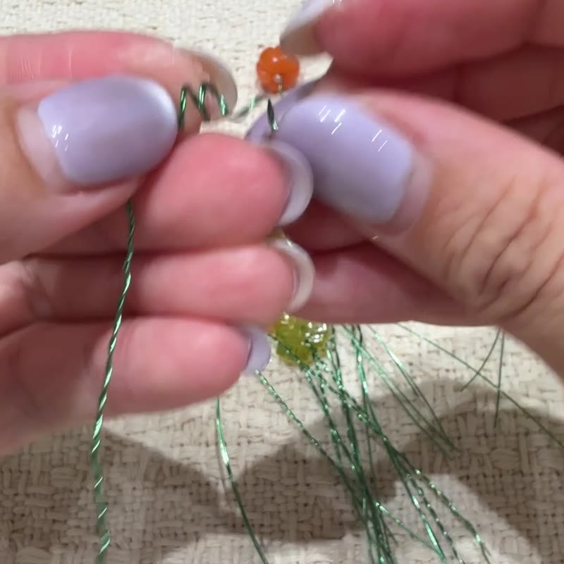 A shaped wire tendril with a long lower stem.